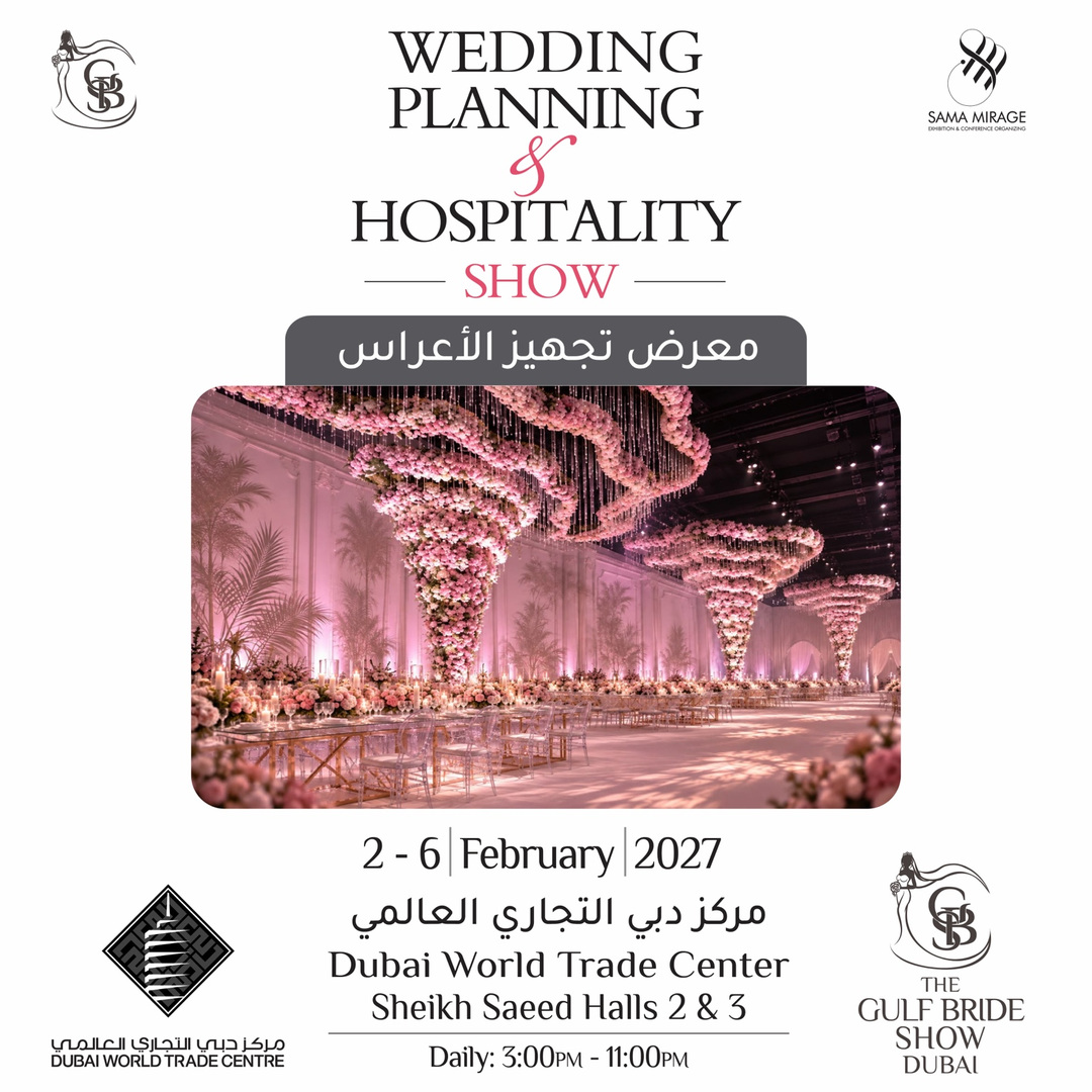 Wedding hall in soft pink light with cascading floral ceiling installations, crystal chairs and set tables for the Wedding Planning and Hospitality Show Dubai 2027